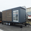 A loading trailer that quickly transforms a unit house into a "trailer house."
